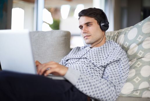 Every song is a reminder of your past. a man listening to music on his laptop.