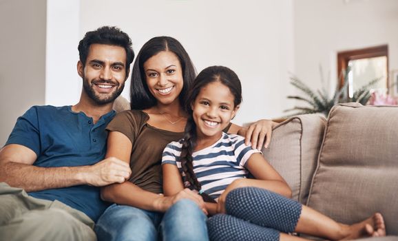 Family turns a house into a home. a happy young family relaxing together on the sofa at home.