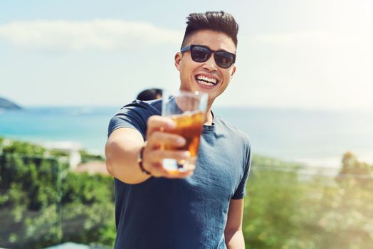 Come join us were here all summer long. Portrait of a handsome young man raising up his glass for a toast while relaxing outdoors with his friends.