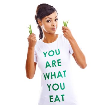 Choose the healthy option... you are what you eat. Portrait of a young woman holding green beans while wearing a t-shirt saying you are what you eat.