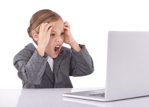 A. A little girl dressed up in business attire and looking frustrated while working on her laptop.