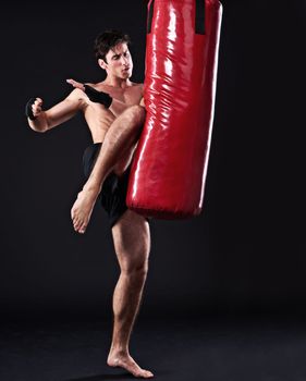 This will drop an opponent instantly. Studio shot of a young mixed martial artist.