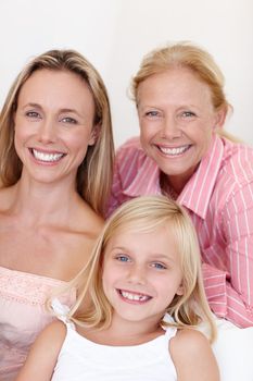 Family beauties. Portrait of an attractive woman sitting with her daughter and her aging mother at home