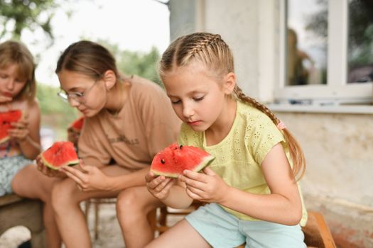 The children eat watermelon in the village