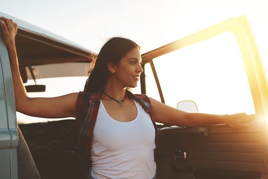 Travel does the mind good. an attractive young woman enjoying a road trip.