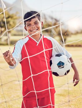 Children, fitness and soccer by boy on soccer field for sports, training and exercise, happy and excited. Kids, sport and football by portrait of young indian football player ready for workout match