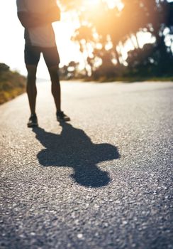 Be fierce and face your own shadow. a runner standing on the road.