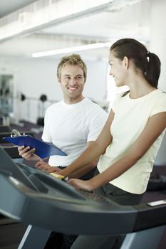 Your progress is pleasing. an attractive young woman working out with her personal trainer.