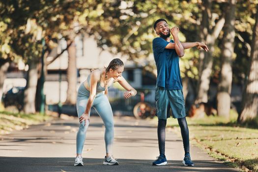 Fitness, stretching and couple rest in park after running, exercise and workout together in city. Health, wellness and interracial couple and doing training, sports and check time for performance