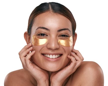 Love your skin and treat it right. a beautiful young woman wearing gold patches under her eyes.