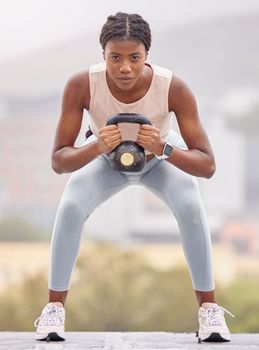 Fitness, squat and black woman with weight in the city, exercise energy and training for health on a rooftop in Turkey. Wellness, strength training and portrait of a girl with a kettlebell for muscle