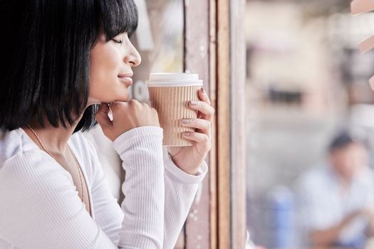 Relax, coffee shop and black woman smell coffee in morning for satisfaction, calm and peace on break. Wellness, lifestyle and happy woman enjoy aroma or scent of tea, latte or beverage by cafe window