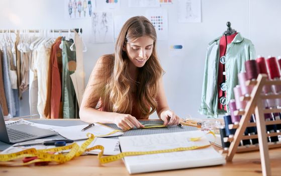 Fashion, designer and creative with woman planning on fabric for manufacturing, retail and tailor in workshop studio. Pattern, textile and clothes with girl and tape for sewing, factory and boutique
