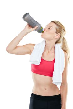 Drink more water. Studio shot of an athletic young woman holding a water bottle.