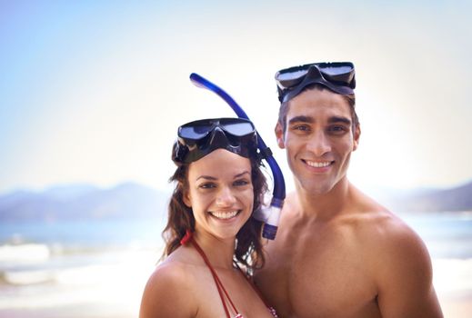 Lets take this date under water. a happy young couple in snorkeling gear at the beach.