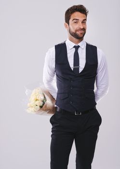 Hes got a surprise for his Valentine. Studio shot of a handsome and well-dressed young man.