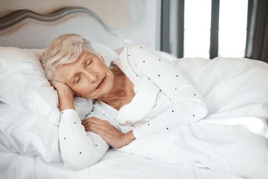 Quality sleep, quality life. a senior woman sleeping in bed in a nursing home.