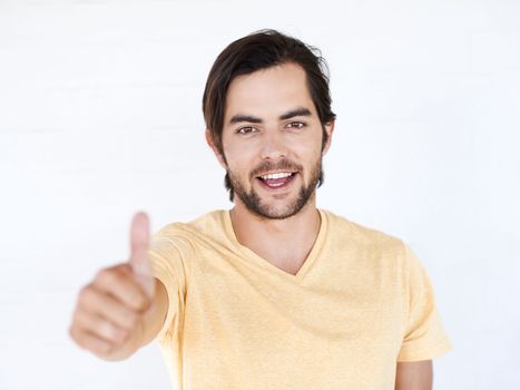 Thumbs up, portrait and man in studio, white background or isolated review. Happy male model, thumb up and support of yes agreement, celebration and like emoji for vote of trust, thank you or success