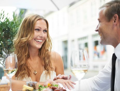 Food, wine and couple at a restaurant for love, celebration or anniversary dinner, happy and bonding. Champagne, romance and woman flirting with man at birthday, event or social gathering together