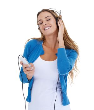 Woman, studio and music headphones with smartphone, smile and relax by white background for happiness. Model, phone and streaming audio on internet app, website or radio while isolated for peace