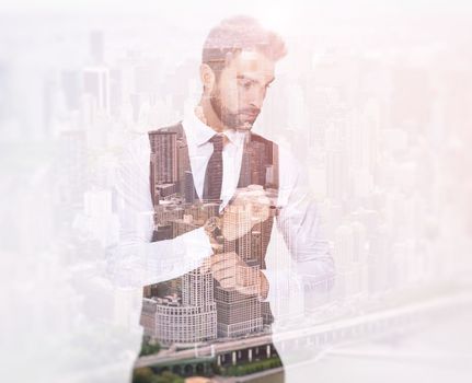 I live the city life. Composite image of a well-dressed man superimposed on an image of a city.