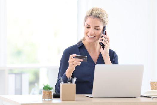 Woman, call and credit card online payment or bank finance security payment in office. Digital online shopping, ecommerce fintech and businesswoman visa banking on internet phone tech at work desk