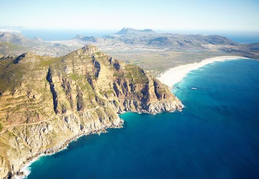 Road to golden beaches. Aerial shot of a road running along the rugged coastline of the western cape.