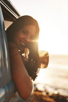 Travel at least once a year. an attractive young woman enjoying a road trip.