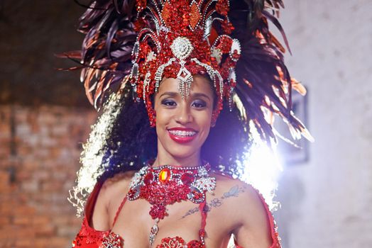 Shes the jewel in the crown. Cropped portrait of an attractive ethnic female in a beaded costume and feather headdress for Mardi Gras.