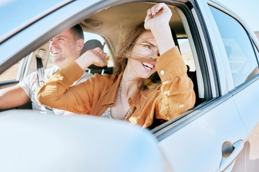Road trip, travel and couple in a car in nature for freedom, vacation and happiness together. Summer, happy and man with an excited woman with smile on a drive in the countryside with transport