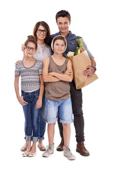 Its hip to be healthy. A trendy family holding a bag of fresh produce together against a white background.
