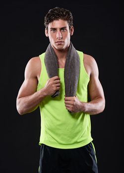 Commit to being fit. Studio shot of a handsome young man in sportswear.