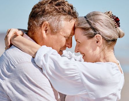 Love, romance and beach with a senior couple hugging outdoor in nature while enjoying a retirement vacation. Travel, summer and together with a mature man and woman pensioner bonding on the coast.