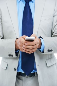 Hes never difficult to contact. a businessman holding a cellphone.