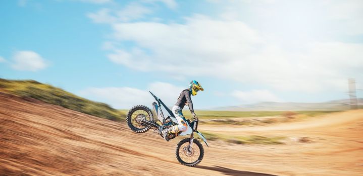 Motorcross, offroad speed and sports on sky for freedom, action or fearless driving. Driver, cycling and power on dirt track, motorcycle competition and motorbike performance on fast adventure course