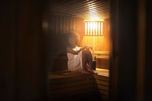 Absolute bliss...A young woman relaxing in the sauna at a spa.
