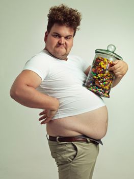 Im sexy and I know it. an overweight man holding a jar of candy.