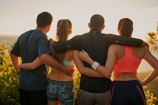 Its the little things that make it worth it. Rearview shot of a fitness group admiring a scenic view.