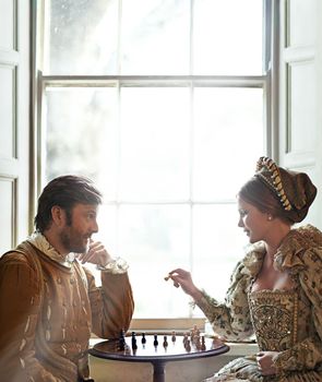 Your move mlove. a an aristocratic couple playing chess.