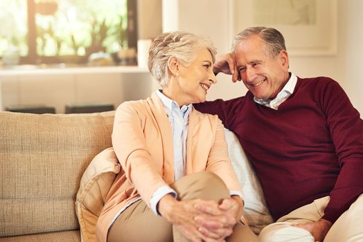 Retirement means more quality time together. a senior couple spending time together in the living room.