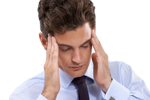 Waiting for the headache to pass. A young businessman gesturing in pain from a headache.