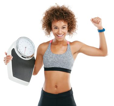 Fat burned is pride earned. Studio portrait of a fit young woman holding a scale against a white background.