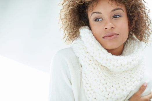 The cold months are no match for her style. an attractive young woman dressed in winter attire.