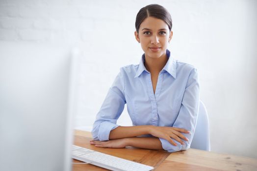 Serious about success. Portrait of a successful young businesswoman at her office desk.