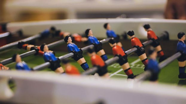 Players play table football in the clubhouse.