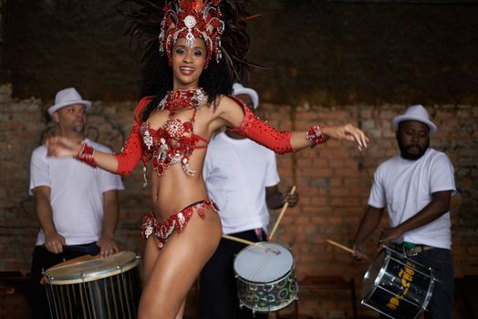 She makes the music come alive. a beautiful samba dancer performing in a carnival.