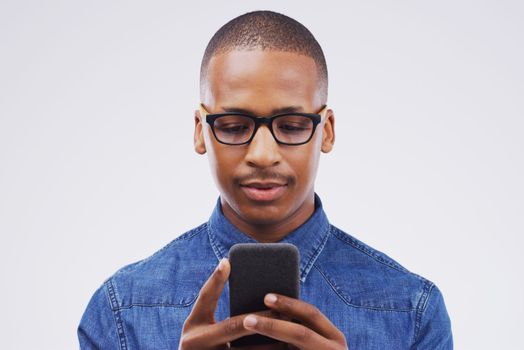 I hope someone shows interest on this dating site. Studio shot of a handsome young man using his cellphone.