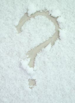 Question mark painted on white snow closeup