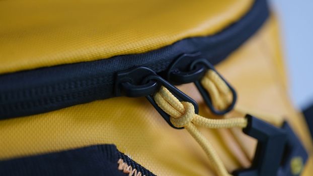 Zipper with lock on yellow backpack closeup