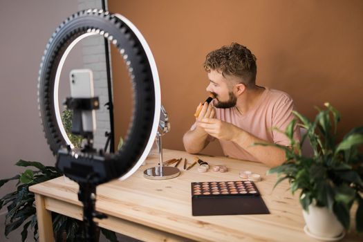 Man make up vlogger recording broadcast about cosmetics and tutorials for make-up artist